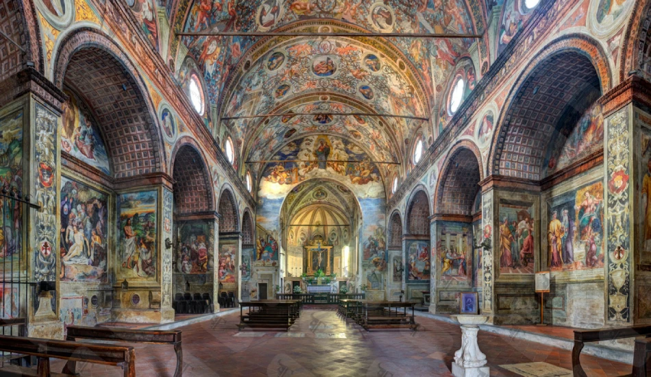 A colorful hall with walls full of paintings and murals. 