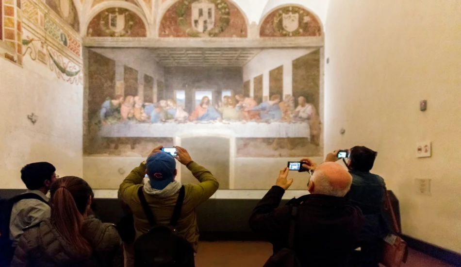 Tourists are clicking pictures of "the Last Supper" painting in their mobile phones.