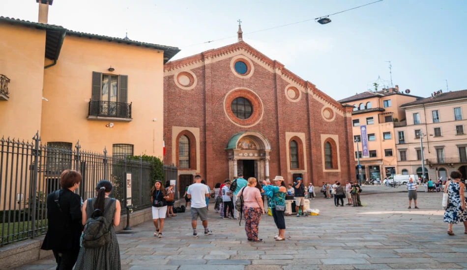 People walking towards Santa Maria della Grezia. 